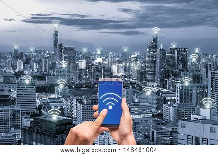 Hand holding mobile phone with wifi network connection network. Wifi network connection concept.