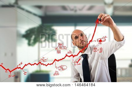 Businessman draw graphics on an arrow uphill