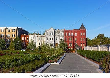 Residential architecture of North East surburb of Washington DC. Colorful row houses surronded by garden.