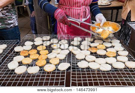 Woman are doing grilled sticky rice with egg.