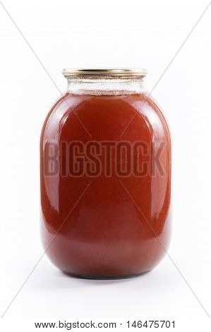 Three-liter jar of tomato juice on a white background