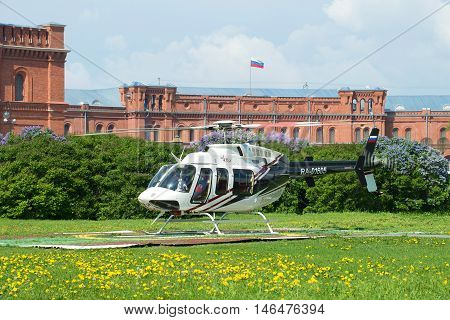 SAINT PETERSBURG, RUSSIA - MAY 22, 2016: Helicopter Bell 407GX (RA-01605) on the landing site at the front of the Museum of artillery. Tourist landmark