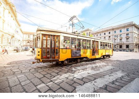 Milan, Italy - June 06, 2016: Old yellow tram with passengers on the street in Milan. The ATM Class 1500 is a series of tram vehicles used from 1927 year by the ATM in Milan