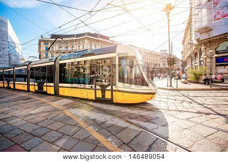 Milan, Italy - June 06, 2016: Yellow tram on Cordusio square in Milan. Cordusio in one of Milan's two main town squares and is a major transportation hub.