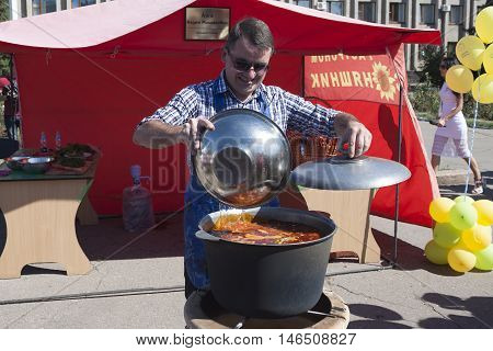 SLOVIANSK UKRAINE - SEPTEMBER 10 2016: Day of Sloviansk. Mayor Vadim M. Lyakh at the Sloviansk Cathedral Square preparing Kettle