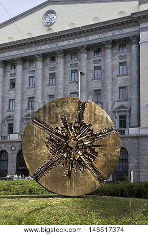 MILAN, ITALY - APRIL 14 2015: Banca Popolare di Milano headquarter with a bronze sculpture by Arnaldo Pomodoro in the foreground