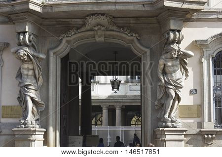 MILAN, ITALY - APRIL 16 2015: Architectural close up of the entrance of Palazzo Arese Litta in Milan with two classic statues at its sides