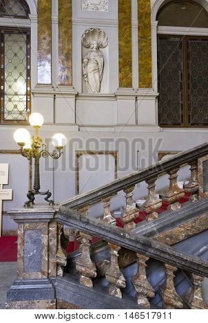 MILAN, ITALY - APRIL 16 2015: Architectural close up of the monumental staircase of Palazzo Arese Litta in Milan with classic statues and marble decorations