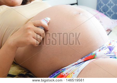 Close Up Pregnant Woman On Bedroom Background