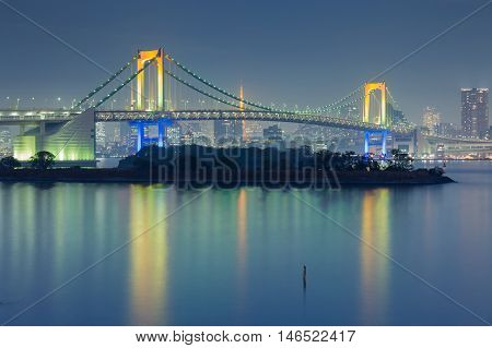 Rainbow bridge connect between Odiaba and Tokyo city downtown at twilight