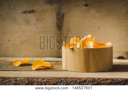 chips in a wooden bowl on the table