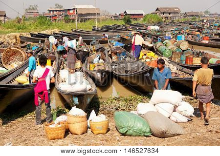 Heho Myanmar - March 02 2011 - Burmese people trading at an floating market. Boats are full of gasoline and other goods
