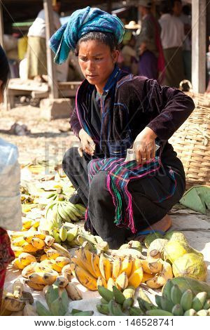 Heho Myanmar - March 02 2011 - Senior Burmese woman selling bananas at five-day market while sitting on the ground