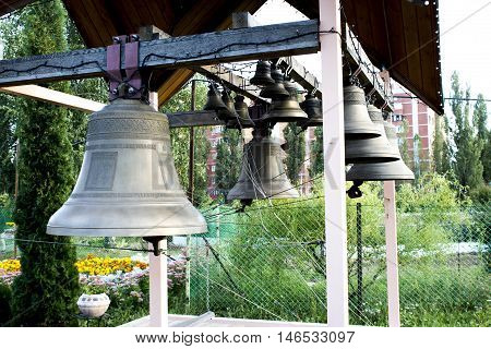 beautiful bells on church bellfry with flowers