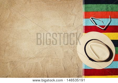 Top view of sandy beach with summer accessories and copy space around products. Blank mock up for blog, advertising or packaging.
