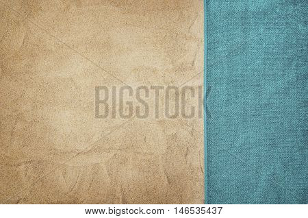 Top view of sandy beach with summer accessories and copy space around products. Blank mock up for advertising or packaging.