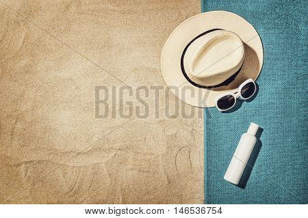 Top view of sandy beach with summer accessories and copy space around products. Blank mock up for advertising or packaging.