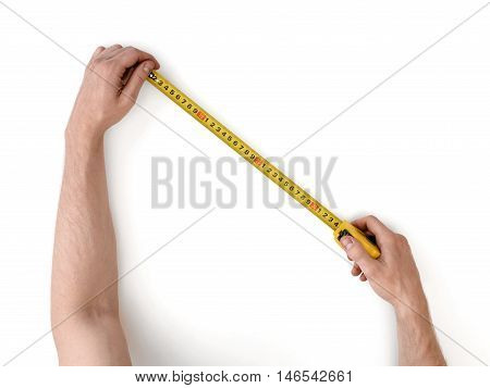 Close-up view of man's hands measuring something with tape-measure isolated on white background. Building and repairing. Handyman. DIY concept.