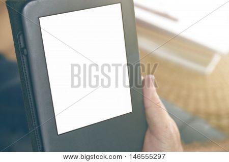 A man holding an ebook reading some documents. Empty copy space for Editor's text.