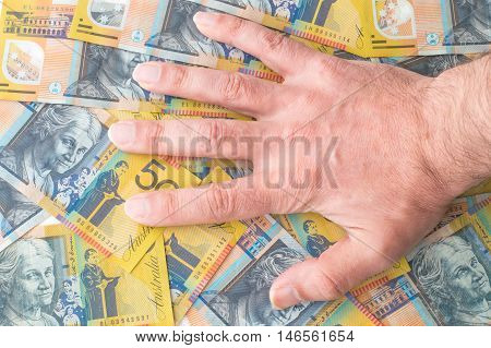Caucasian Man Hand on Australian Dollar Banknotes