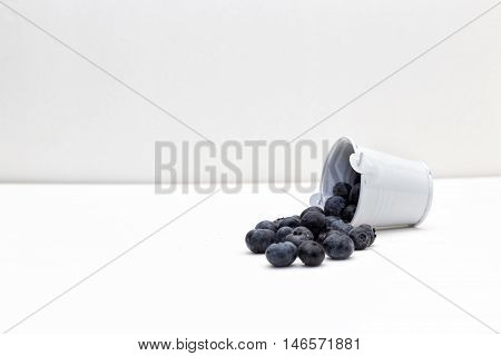 The bucket of the blueberries fell down