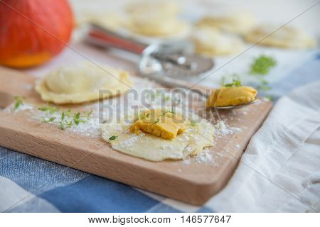 homemade stuffed with pumpkin ravioli on a wooden board