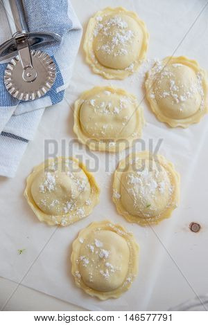 homemade stuffed with pumpkin ravioli on a wooden board