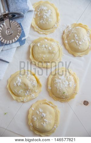 homemade stuffed with pumpkin ravioli on a wooden board