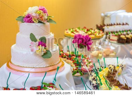 Authentic buffet, assorted fresh fruits, berries and citrus fruits. Morning atmospheric lighting, fashionable trendy spot soft focus. Preparation for design creative menu.