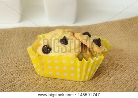 Chicolate chip cookies on brown colored cloth on white table