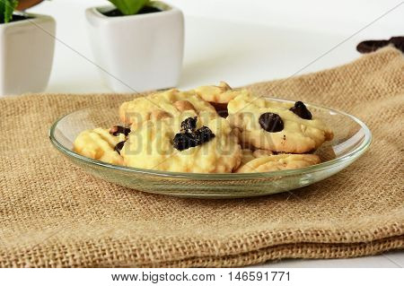 Chicolate chip cookies on brown colored cloth on white table