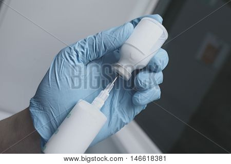 Male nurse filling the syringe. Treatment in hospital