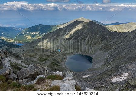 Dark clouds over Ledenoto (Ice) Lake, panorama from Musala Peak, Rila mountain, Bulgaria