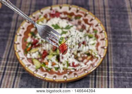 Macro Shot Of Shopska Salad On A Fork.