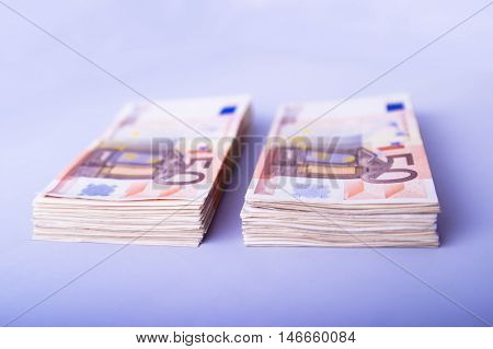 Two Piles Of Fifty Euros