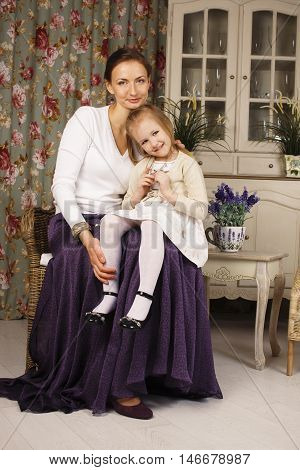 young mother with daughter at luxury home interior vintage, old fashion relashionship family