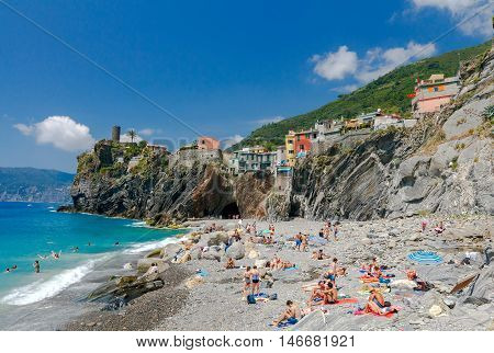 Vernazza Italy - July 29 2016: Municipal pebble beach in the old village of Vernazza. Parco Nazionale delle Cinque Terre Liguria Italy.