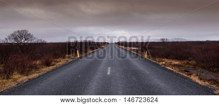 Highway countryside straight empty road leading to the snowy mountains at Snæfellsnes Peninsula in Iceland
