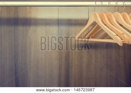 Clothes hanger in wardrobe. Text space available.