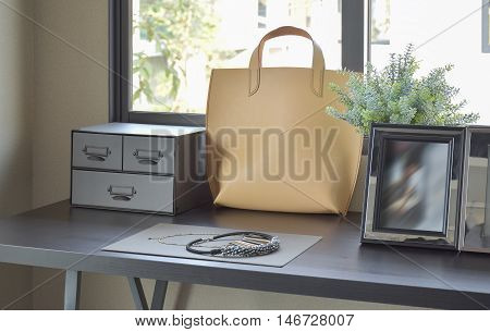 Female's Accessories With Handbag And Jewelry On Wooden Dressing Table