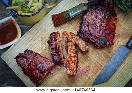 Home made pork bbq ribs with french fries on table
