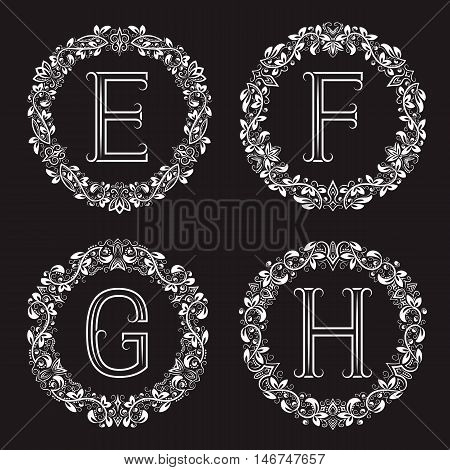 Set of vintage monograms in round wreath. E F G H white letters in floral frames.