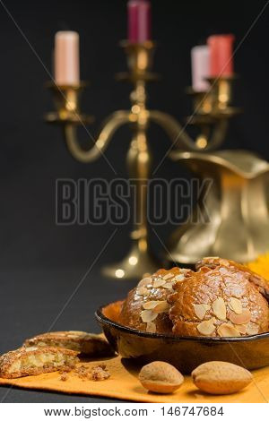 Typical Dutch filled spicy cookies with almonds on autumn colored and dark background