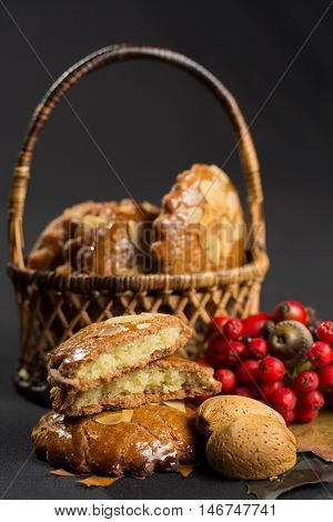 Typical Dutch filled spicy cookies with almonds on autumn colored and dark background