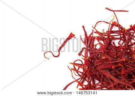 Heap of saffron isolated on white background closeup view from above.