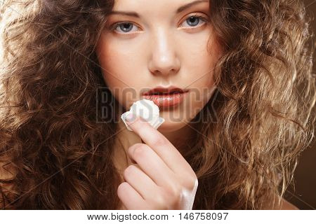 beauty portrait of a cute  girl in act to eat a candy with cocoanut
