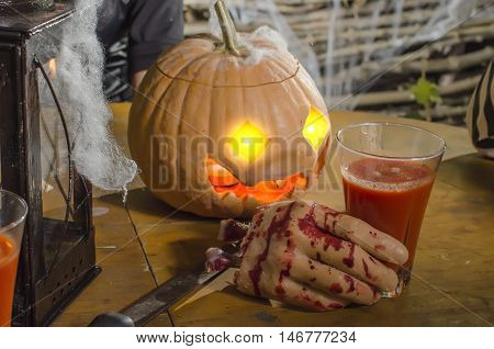 scenery of the chopped-off hand and pumpkin for a holiday Halloween