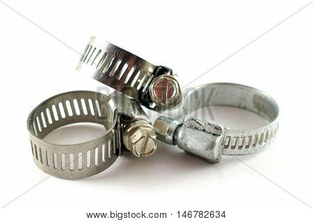 Three hose clamps. Closeup with white background