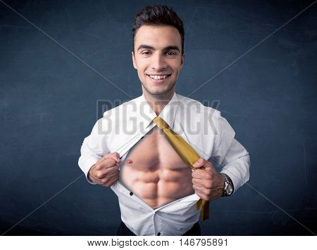 Businessman tearing off his shirt and showing mucular body concept on background