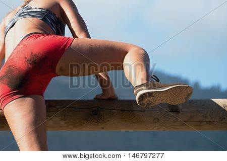 Running over obstacles female race participant,extreme sport